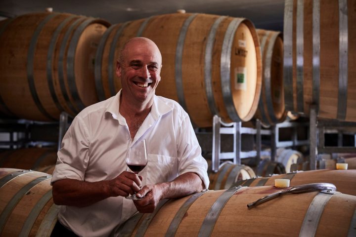 David Lowe sitting in a chair in front of a barrel